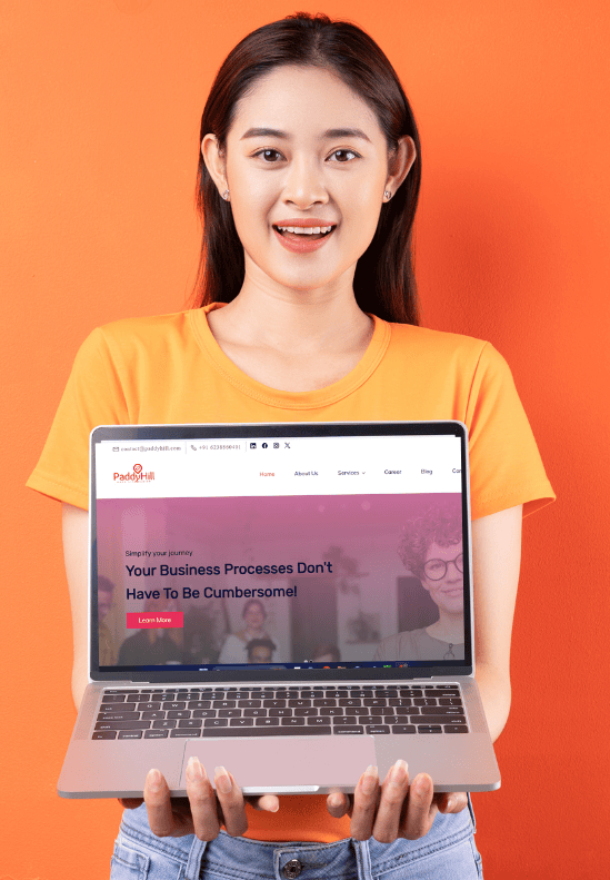 A girl holding the laptop showing the paddyhill website