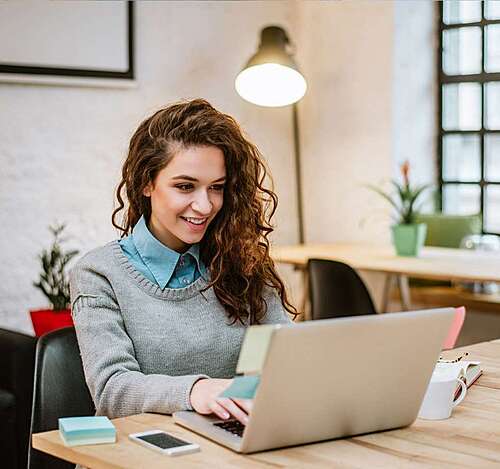 A woman looking at the laptop